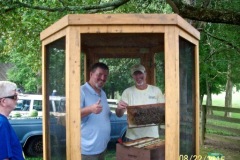 Johnny Mills & Randy Stinson in the bee cage with a hive.